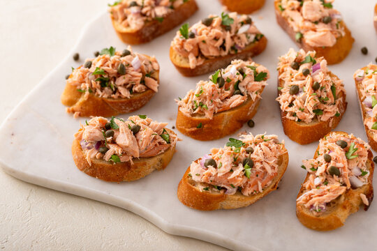 Hot smoked salmon crostini with smoked or roasted salmon, red onion and capers