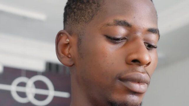 Closeup black male portrait alert showing layered profile and upward glances, studio interior with graphic backdrop, confident expression, sharp lighting, painterly tones referencing portrait
