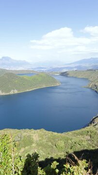 Cotacachi, Ecuador - November 5, 2025: Cuicocha Lagoon is a crater lake at the foot of the Cotacachi Volcano. Its deep blue waters and volcanic islets create a stunning natural landscape.