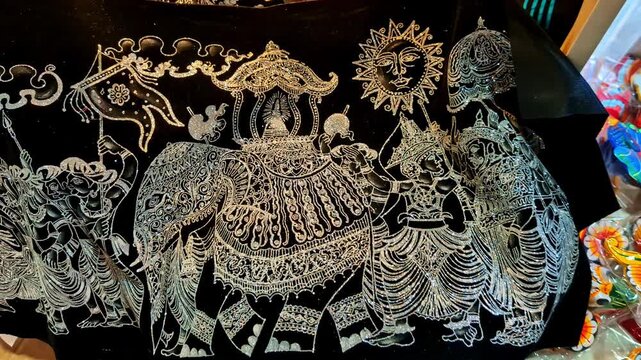 Close up of traditional Sri Lankan elephant embroidery in silver thread on black fabric. Detailed handcrafted textile art inspired by cultural and religious motifs.
