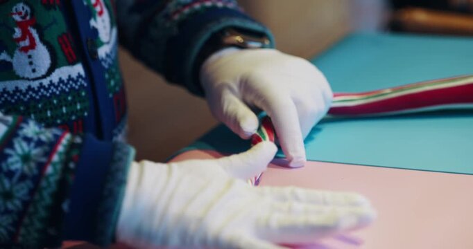 Man making Christmas colorful sugar candy cane sticks, slow motion