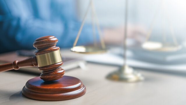 Judge gavel and justice scale on desk in law office, representing legal system, court decision, litigation process and professional legal services concept.