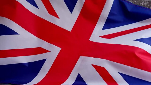 National symbol of Great Britain. British full framed wave UK fabric flag background. Copy space for your text. Concept of Independence