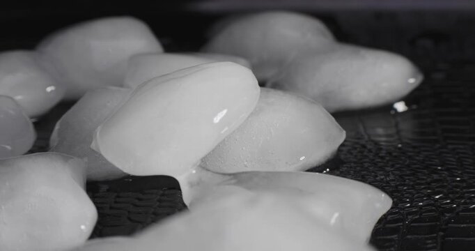 Time lapse of melting ice cubes on black background