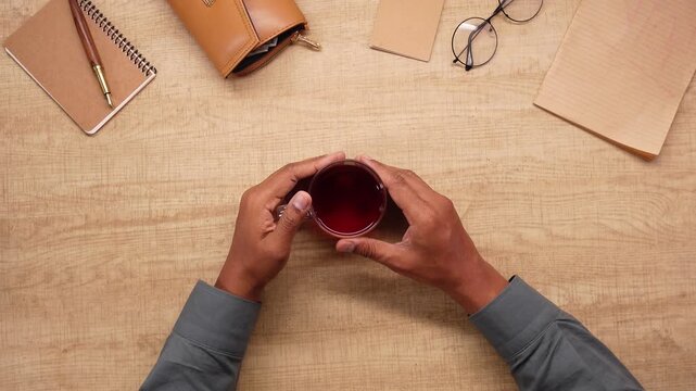 Making tea at a wooden table with notes and glasses