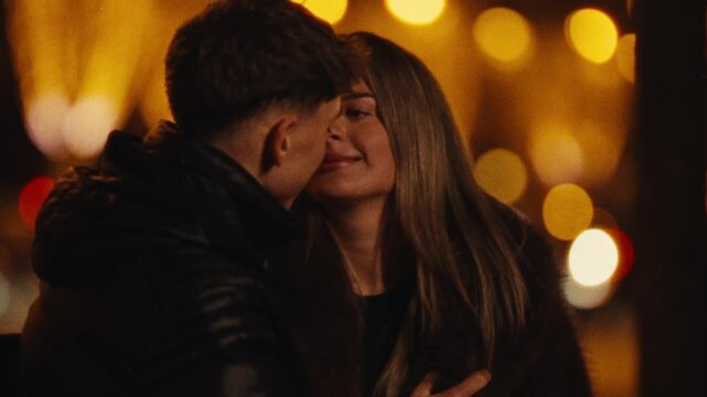 A romantic city trip A couple in love embraces in Paris at night filmed in a Super 8 style with handheld camera movement and a blurry bokeh background travel content Valentine's Day promotions or rela