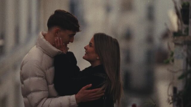 Showcasing a romantic getaway concept a young couple embracing in a Parisian cityscape The clip is shot in a Super 8 film style with a handheld camera creating a blurry vintage aesthetic travel romanc