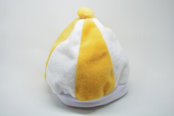 Yellow and white striped baby beanie hat isolated on white background, soft plush winter cap for infants and toddlers, cozy fleece headwear for kids fashion and warm seasonal accessory © Other.Side