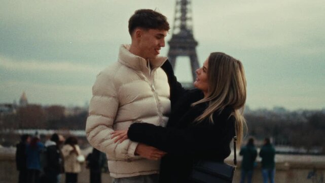 A romantic city trip A couple in love embraces in Paris with the Eiffel Tower in the background shot in a Super 8 film style with a handheld blurry aesthetic travel vlogs romantic comedies or document