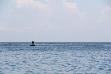 Obraz premium Small navigation buoy in vast ocean with calm waters