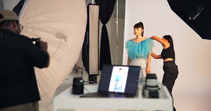 Preparation, photoshoot and people on set with stylist, getting ready and clothing option in studio. Collaboration, model or film team with planning, fashion catalog or backstage in media production