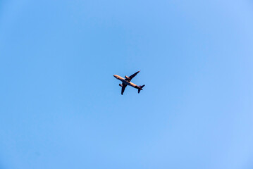 Airplane is flying on isolated blue sky