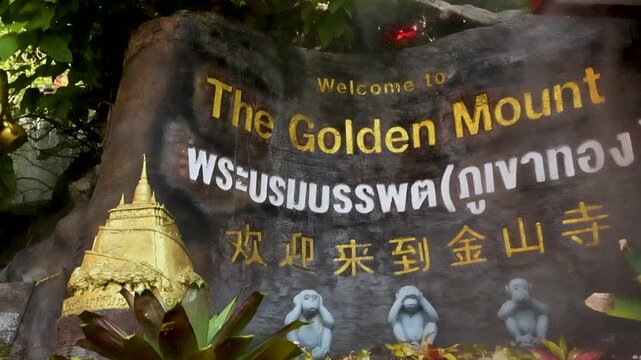 Golden Buddha Statue and Welcome Sign at Wat Saket Golden Mount Bangkok Thailand