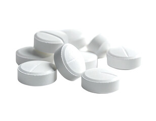 A scattered pile of small white circular tablets with a deep groove