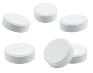 White circular pills with a score line, arranged in a scattered pattern