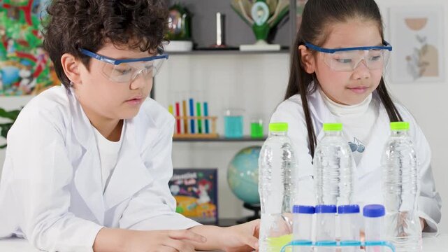 Asian Children Conducting Bernoulli's Principle Science Experiment with Ping Pong Ball