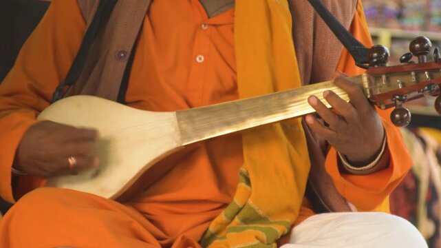 Baul Folk Singer Performing with Ektara at Rural Fair in Kolkata India