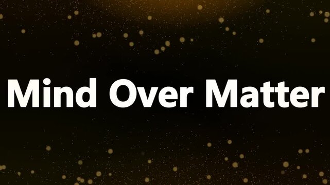 Motivational cinematic text display featuring the powerful phrase mind over matter against a dark background illuminated by golden bokeh lights.