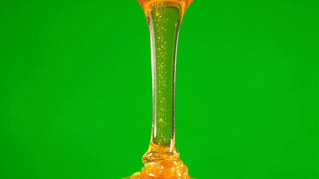 Golden Honey Dripping in Smooth Stream on Green Screen Background