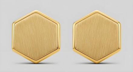 Fototapeta premium Two gold-colored hexagonal earrings displayed side by side on a plain background