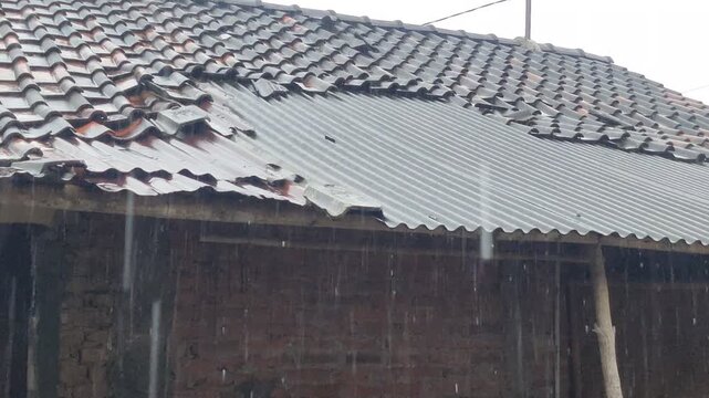 Heavy Rain Pouring on Rustic Village House Roof in Rural Area