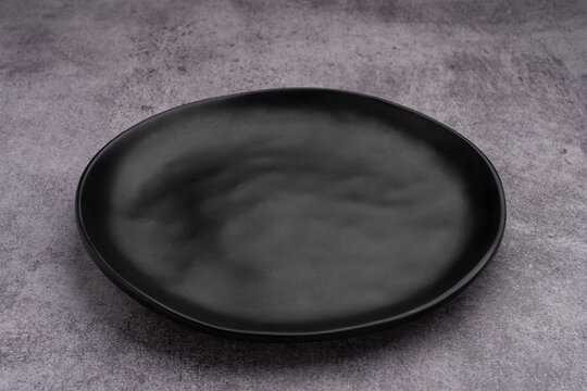 Black Rounded Ceramic Plate Marble Background
