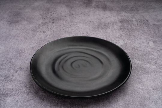 Black Rounded Ceramic Plate Marble Background