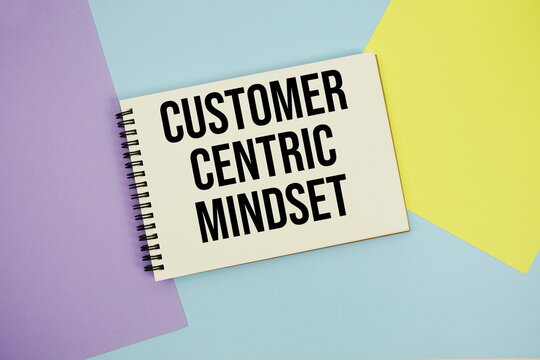 Customer Centric Mindset text written on notepad flat lay on multicolor pastel background