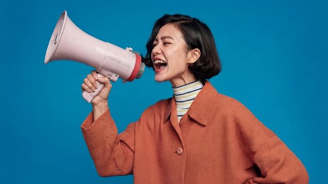 Confident woman shouting into megaphone on bright backdrop conveying determination civic engagement and vibrant contemporary communication