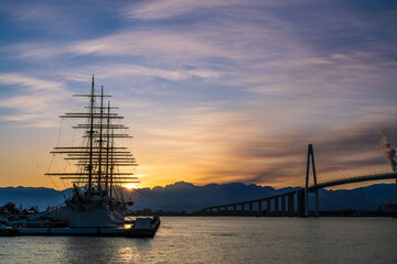 夜明けの海王丸パークから朝焼けの立山連峰を背景に新湊大橋と海王丸