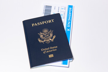 US passport with boarding passes on white. Boarding and airport check in concept. American passport cover with airline tickets. Passport and boarding pass. Passport and flight documents.