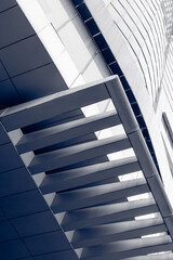 Obraz premium Metal louvers angling across modern facade in upward perspective