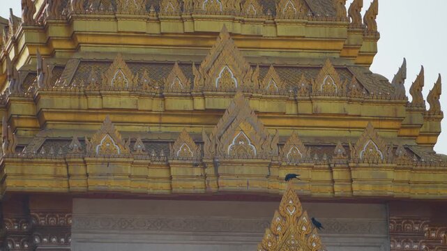 Close view of Thai Buddhist temple roof patterns and ornamental design.