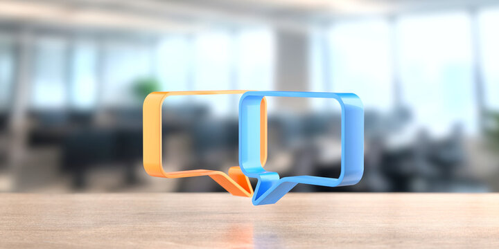 Two colored speech bubble icons in orange and blue on wooden desk with blurred office background for communication banner and social media design.3d render