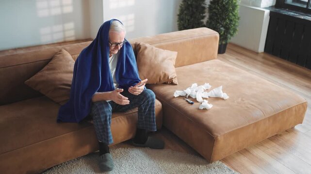 Elderly man feeling pain in chest calling by video in smartphone to doctor. Portrait of senior sick male person caught cold or heart attack, suffering of lung ache, telemedicine and modern technology