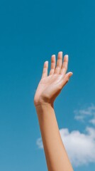 Reaching for the sky hand gesture against a blue sky nature photography outdoor scene inspirational concept