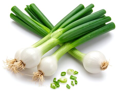Bunch of fresh spring onions with green stalks and white bulbs, some sliced on a white surface