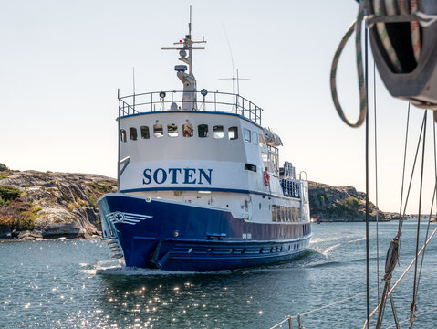 Passenger ship M/S Soten navigating Sotekanalen, Sote Canal, Bohusl&auml;n, west coast Sweden, with rocky coastline seen from sailboat