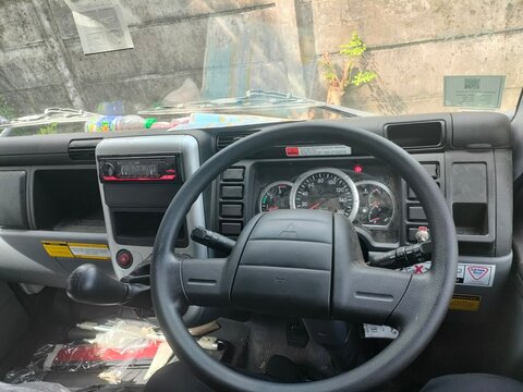 Close-up of a modern car interior dashboard with black textured surface and air conditioning vents. Concept of automotive design, vehicle interior maintenance, and contemporary transportation.