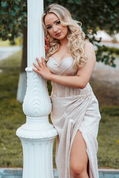 Blonde Teen in Sparkle Prom Dress, Leaning on Pillar, under the