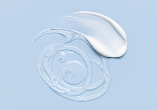 samples of cosmetic care products smear of cream and gel texture on a light blue background, moisturizing and skin care concept