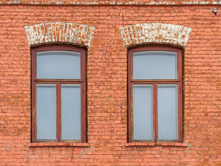 Fototapeta premium Two windows of the old mansion 19 century with brown bricks wall