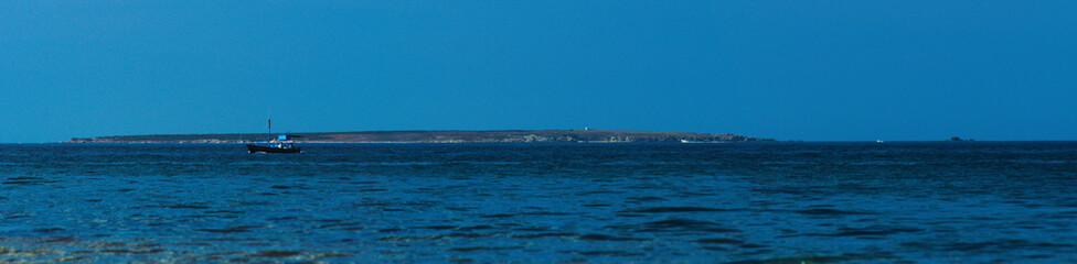 Fototapeta premium Wide view of Mal di Ventre (Sardinian: Malu 'Entu) an island located in the marine protected area off the west coast of Sardinia, Italy