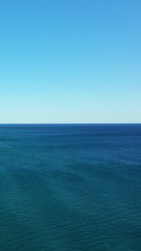 Tranquil seascape with deep blue water meeting a clear sky, captured off the coast of Acciaroli, Italy. Perfect for backgrounds or concepts of peace and serenity.