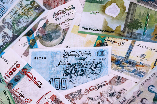 Algerian dinar money bills pile on table. Algeria banknotes of DZD currency close up.
