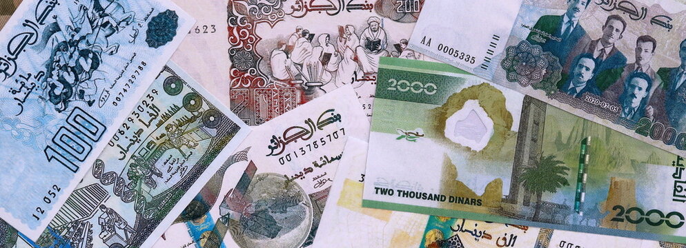 Algerian dinar money bills pile on table. Algeria banknotes of DZD currency close up.
