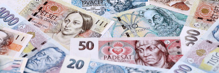 Obraz premium Czech koruna money bills pile on table. Czech Republic banknotes of CZK currency close up.