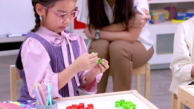 Elementary School Girl Counting Colorful Math Manipulative Blocks