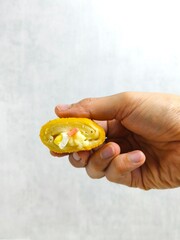 Hand Holding Risol Mayo &ndash; Crispy Indonesian Fried Roll with Mayonnaise, Smoked Beef and Boiled Egg