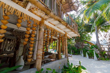 Tropical hut with hanging gourds and wooden beams